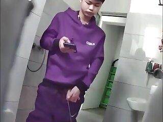 A male student is pissing in the toilet cam boys porn