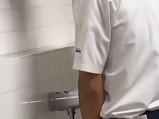 A male student is pissing in the toilet 2