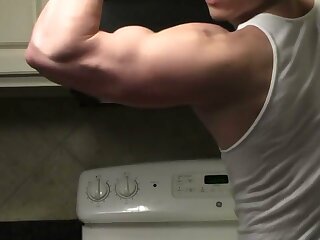 Muscle bro showing off his sexy muscles in a wifebeater.